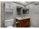 This bathroom features a cabinet, sink, toilet, and mirror at 3705 W Villa Theresa Dr, Glendale, AZ 85308