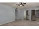 A carpeted bedroom featuring a ceiling fan and large closet with mirrored doors at 3705 W Villa Theresa Dr, Glendale, AZ 85308
