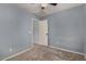 This bedroom features a ceiling fan, carpet, and walls painted blue at 3705 W Villa Theresa Dr, Glendale, AZ 85308