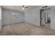 This carpeted bedroom features a ceiling fan and access to other rooms at 3705 W Villa Theresa Dr, Glendale, AZ 85308