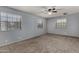 This carpeted bedroom features three windows allowing for plenty of natural light at 3705 W Villa Theresa Dr, Glendale, AZ 85308