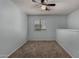 A carpeted bedroom features a ceiling fan and bright natural light from a window at 3705 W Villa Theresa Dr, Glendale, AZ 85308