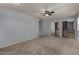 A carpeted bedroom featuring a ceiling fan and a large closet with mirrored doors at 3705 W Villa Theresa Dr, Glendale, AZ 85308