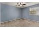 This bedroom features a ceiling fan, carpet, and walls painted blue at 3705 W Villa Theresa Dr, Glendale, AZ 85308