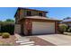 Charming home featuring a brick-accented garage, long driveway, and welcoming walkway at 3705 W Villa Theresa Dr, Glendale, AZ 85308