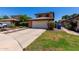 Charming home featuring a brick-accented garage and extended driveway with fresh landscaping at 3705 W Villa Theresa Dr, Glendale, AZ 85308