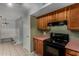 Traditional kitchen with wooden cabinets and black appliances near the dining area at 3705 W Villa Theresa Dr, Glendale, AZ 85308