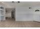Open-concept living room featuring tiled floors and a doorway to another room at 3705 W Villa Theresa Dr, Glendale, AZ 85308