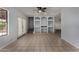 Bright living room featuring tiled flooring, built-in shelving, and double doors at 3705 W Villa Theresa Dr, Glendale, AZ 85308