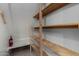 This storage area features wood shelves at 3705 W Villa Theresa Dr, Glendale, AZ 85308