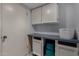 This storage area features white cabinets and countertop space at 3705 W Villa Theresa Dr, Glendale, AZ 85308
