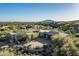 Expansive aerial view of custom home with desert landscaping, mountains, and blue skies at 39089 N 102Nd Way, Scottsdale, AZ 85262