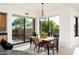Bright dining area with access to patio and views of mature landscaping at 39089 N 102Nd Way, Scottsdale, AZ 85262