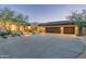 Beautiful exterior of custom home with stone accents, desert landscaping, and an extended driveway at 39089 N 102Nd Way, Scottsdale, AZ 85262