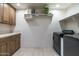 Laundry room complete with ample cabinet space and modern washer and dryer at 39089 N 102Nd Way, Scottsdale, AZ 85262