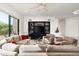 Cozy living room showcasing built-in shelving, fireplace, and comfortable furnishings at 39089 N 102Nd Way, Scottsdale, AZ 85262