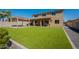 Expansive backyard with artificial turf, pergola, and ample space for outdoor living at 408 W Sweet Shrub Ave, San Tan Valley, AZ 85140