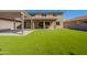 Wide view of backyard featuring artificial turf, covered patio, and pergola at 408 W Sweet Shrub Ave, San Tan Valley, AZ 85140