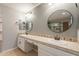 Bathroom featuring double sinks, tiled countertop, and round mirrors at 408 W Sweet Shrub Ave, San Tan Valley, AZ 85140