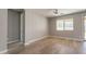 Neutral bedroom with wood floors, bright window, and door to the back at 408 W Sweet Shrub Ave, San Tan Valley, AZ 85140