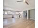 Spacious open-concept kitchen with white cabinets, stainless steel appliances, and wood floors at 408 W Sweet Shrub Ave, San Tan Valley, AZ 85140