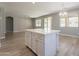 Bright kitchen with white island that connects to living space with lots of sunlight at 408 W Sweet Shrub Ave, San Tan Valley, AZ 85140