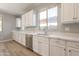 Bright kitchen featuring white cabinets and countertops, stainless steel appliances, and wood floors at 408 W Sweet Shrub Ave, San Tan Valley, AZ 85140