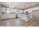 Bright kitchen featuring white cabinets, an island, modern appliances, and wood floors at 408 W Sweet Shrub Ave, San Tan Valley, AZ 85140