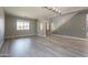 Spacious living room with wood floors, neutral paint, modern chandelier, and staircase at 408 W Sweet Shrub Ave, San Tan Valley, AZ 85140