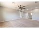 Open loft space with carpet, ceiling fan, and a staircase with white railing at 408 W Sweet Shrub Ave, San Tan Valley, AZ 85140