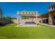 Backyard view featuring a pergola and artificial grass at 408 W Sweet Shrub Ave, San Tan Valley, AZ 85140