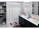 Bathroom featuring a double vanity, a shower-tub combo and ample shelving for organization at 42087 W Manderas Ln, Maricopa, AZ 85138