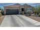 Charming single-story home with a well-maintained front yard, desert landscaping, and a two-car garage at 42087 W Manderas Ln, Maricopa, AZ 85138
