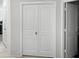 Hallway with double door closet and neutral paint, providing a clean and modern aesthetic at 42087 W Manderas Ln, Maricopa, AZ 85138