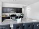 The kitchen features dark cabinets, stainless steel appliances, and a large center island with gray granite countertops at 42087 W Manderas Ln, Maricopa, AZ 85138