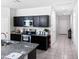 A well lit kitchen with dark cabinets, stainless steel appliances, and gray granite countertops at 42087 W Manderas Ln, Maricopa, AZ 85138
