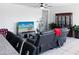 A comfortable living room with a large TV, reclining sofa, and decorative cabinet at 42087 W Manderas Ln, Maricopa, AZ 85138