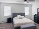 Comfortable main bedroom with soft carpet, serene colors and a stylish upholstered bed frame at 42087 W Manderas Ln, Maricopa, AZ 85138
