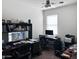 Functional office with multiple workstations, a ceiling fan, and natural light for enhanced productivity at 42087 W Manderas Ln, Maricopa, AZ 85138