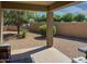 Covered patio with desert landscaping and privacy wall at 42087 W Manderas Ln, Maricopa, AZ 85138