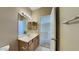 Bathroom features a sink, a vanity with wood cabinets, and a large mirror at 4776 W Eva St, Glendale, AZ 85302