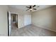 A neutrally decorated bedroom with a ceiling fan, closet, and carpeted flooring at 4776 W Eva St, Glendale, AZ 85302