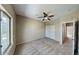 A brightly lit bedroom with a closet, carpet, and a ceiling fan at 4776 W Eva St, Glendale, AZ 85302