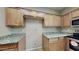 Cozy kitchen featuring granite countertops and wood cabinets at 4776 W Eva St, Glendale, AZ 85302