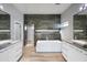 Modern bathroom with a freestanding tub, double vanity, and tile accent wall at 6529 N Mountain View Dr, Paradise Valley, AZ 85253