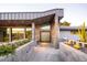 Inviting front entry with a unique door design, complemented by elegant landscaping and concrete accents at 6529 N Mountain View Dr, Paradise Valley, AZ 85253