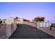 Eye-catching exterior showcasing a modern architectural design with a gated driveway leading up to the property at 6529 N Mountain View Dr, Paradise Valley, AZ 85253