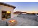 Outdoor living area with a fire pit, scenic mountain views, and glass door to the inside at 6529 N Mountain View Dr, Paradise Valley, AZ 85253