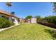 Spacious backyard with lush green lawn, garden shed, and mature landscaping at 10807 W Morten Ave, Glendale, AZ 85307
