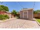 Backyard featuring storage shed, string lights, and stone pavers, perfect for outdoor enjoyment at 10807 W Morten Ave, Glendale, AZ 85307